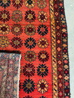 Persian runner rug with bold flower power design with an underside view of the weave.