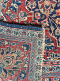 Underside view of classic curvilinear antique Persian Tabriz rug ideal for entryways and living spaces.