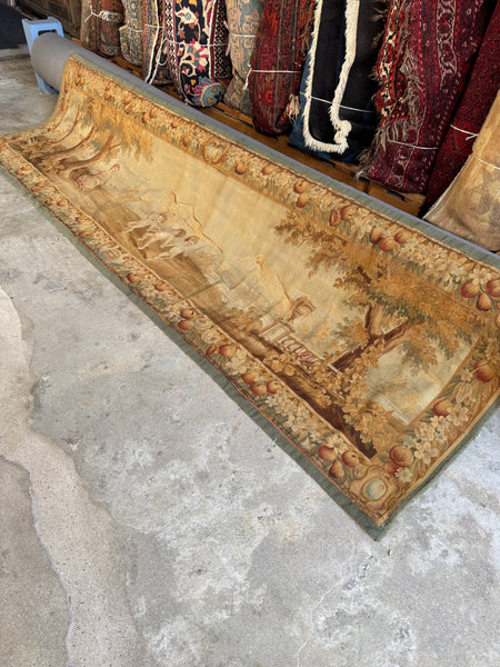 Antique French wool tapestry with pastoral music scene and fruit border.