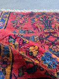 Small 2x2 square antique wool table rug with floral border in aqua blue and berry pink.