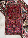 2x4 vintage Persian Sarouk rug with a rich red field and floral sprays.