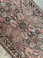 Long Persian runner from the 1930s with floral and paisley motifs.