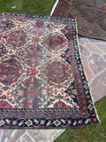 Late 19th century Persian Kerman rug handwoven in vegetable-dyed wool with an intricate lattice and medallion design.