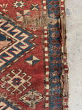 3x5 brick red tribal rug, antique Kazak rug with indigo borders and geometric village weaving.