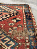3x5 antique tribal rug, red and navy Kazak rug showing authentic age wear and exposed foundation.