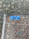 Vintage 7x10 Persian rug from Tabriz with a muted celadon green field, tightly woven floral lattice and even wool pile.