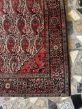 antique Persian rug with saturated natural dyes corner design