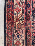 Distressed antique Persian runner close-up revealing natural vintage wool loss and authentic aged texture.