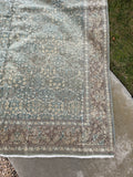 Vintage Persian wool rug 6'10 x 9'10 with a pale green Tabriz field, classical floral motifs and an intricate floral border.