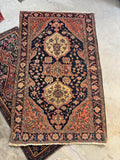 Decorative vintage rug with intricate patterns on a concrete floor