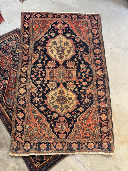 Decorative vintage rug with intricate patterns on a concrete floor