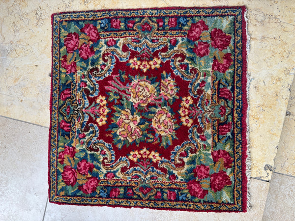Decorative floral vintage persian rug on a stone floor