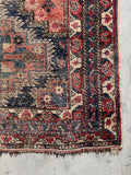 5x6 early 1900s Afshar rug with low pile, age worn character, and vegetable dyed wool colors.