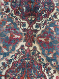Antique Persian floral rug with an ivory field, interconnected medallions and shades of berry red, rust, taupe and blue.