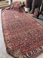 Clean antique rug laid flat on floor with underside showing