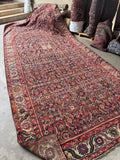 Clean antique rug laid flat on floor with underside showing