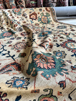 Antique Persian rug featuring vibrant floral motifs.