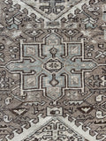 Close-up of a vintage persian neutral heriz rug with medallion design