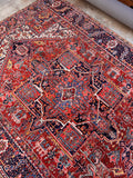 Hand knotted Persian Heriz rug from the 1920s with classic geometric tribal design.