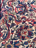 Close up view of the antique wool rug highlighting its subtle sheen and rich color palette.