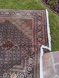 Vintage Persian Tabriz area rug with a fine weave, traditional Mahi motifs and a large decorative central medallion.