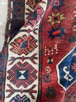 Antique runner with low pile, floppy handle, and worn character.