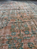 Antique Lilihan rug with floral patterning and faded warm hues