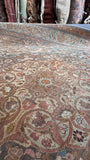 Dusty rose, ivory and cocoa brown floral details on a Persian Tabriz rug in the 9x12 size range.
