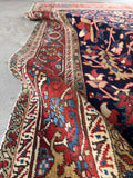9x12 navy blue antique area rug featuring a classic Persian Heriz tribal design and low pile wool.