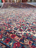 Close up of 1920 hand-knotted antique Persian Kerman rug.