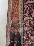 9x12 navy blue hand-knotted Persian Heriz rug with scattered vintage wear and timeless character. 