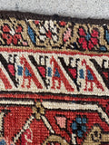 9x12 navy blue antique Persian rug with classic Heriz design and hand-restored side bindings.