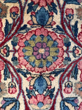Vegetable-dyed wool texture showing rich rose-pink, navy blue, and soft green tones.
