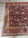 One end of 9x12 navy blue Persian Heriz rug with faded rust border and beautifully aged vegetable-dyed wool.