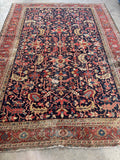 9x12 navy blue antique area rug featuring a classic Persian Heriz tribal design and low pile wool.