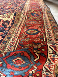 9x12 navy blue Persian Heriz living room rug with rust border and authentic 1920s craftsmanship.