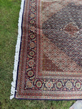 Mid-century Persian Tabriz rug handwoven with vegetable-dyed wool, silk highlights and an intricate medallion design.