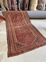 Antique Persian Ferahan rug with worn patina and boteh paisley motifs

