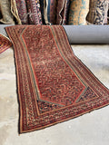Antique Persian Ferahan rug with worn patina and boteh paisley motifs

