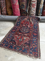 Antique Persian rug with tribal Kurdish design, worn wool, and low pile, size 3'3 x 6'4, circa 1920s

