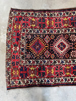 One end view showing high-contrast tribal motifs and rich colors.