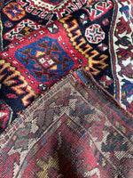 Folded corner of Kazak rug showing thickness, weave, and craftsmanship.