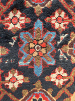 Up-close view of Mina Khani pattern with navy background and vegetable-dyed wool