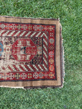 Decorative Persian rug with intricate patterns and wear