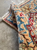 Vegetable-dyed Persian Kerman rug in ivory, blue, cranberry red and soft green.