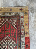 Corner view of geometric border motifs on an antique Serab runner.