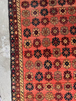 Persian runner with alternating floral motifs in rich colors.