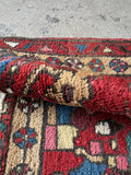 Persian rug with abstract botanical motifs in jewel tones.