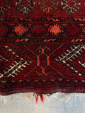 Geometric tribal motifs in a structured, linear arrangement along border bands.