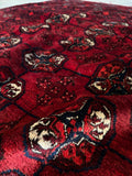 Close-up of linear medallion design on a saturated red vintage Afghani rug.